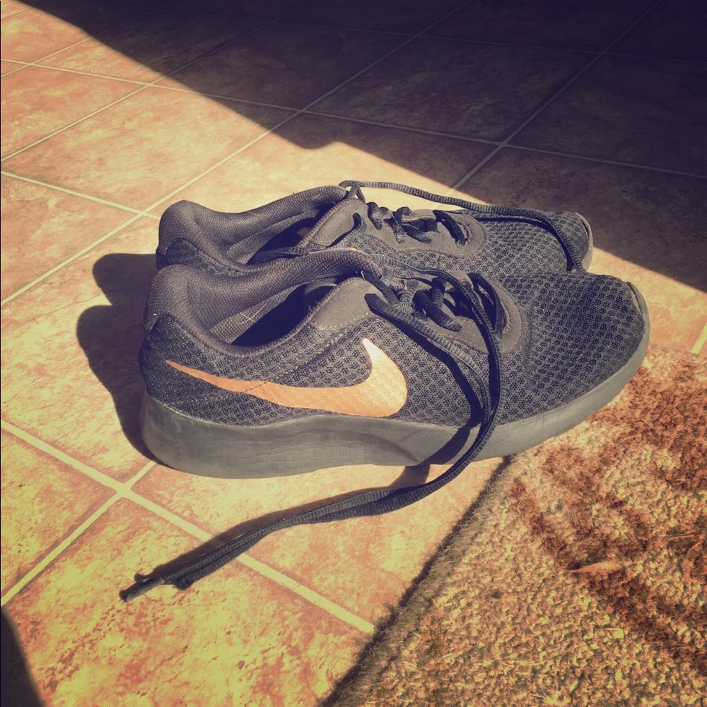 Black and gold Nike sneakers